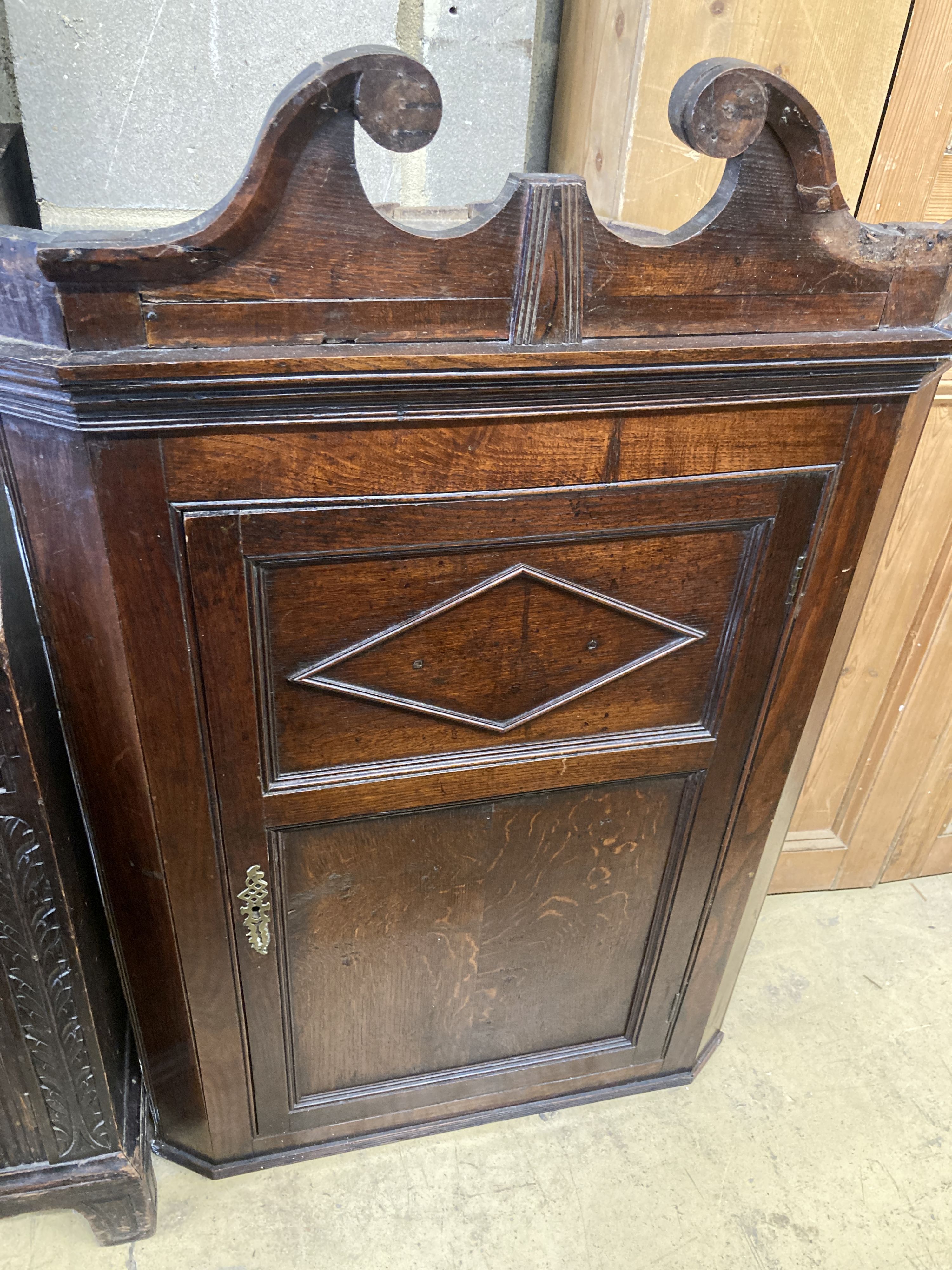 A George III oak hanging corner cabinet, width 72cm, depth 36cm, height 110cm